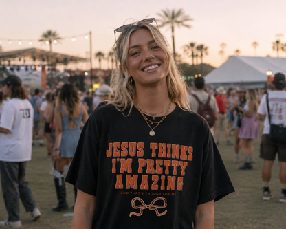 Woman wearing a black t-shirt with text at a festival.
